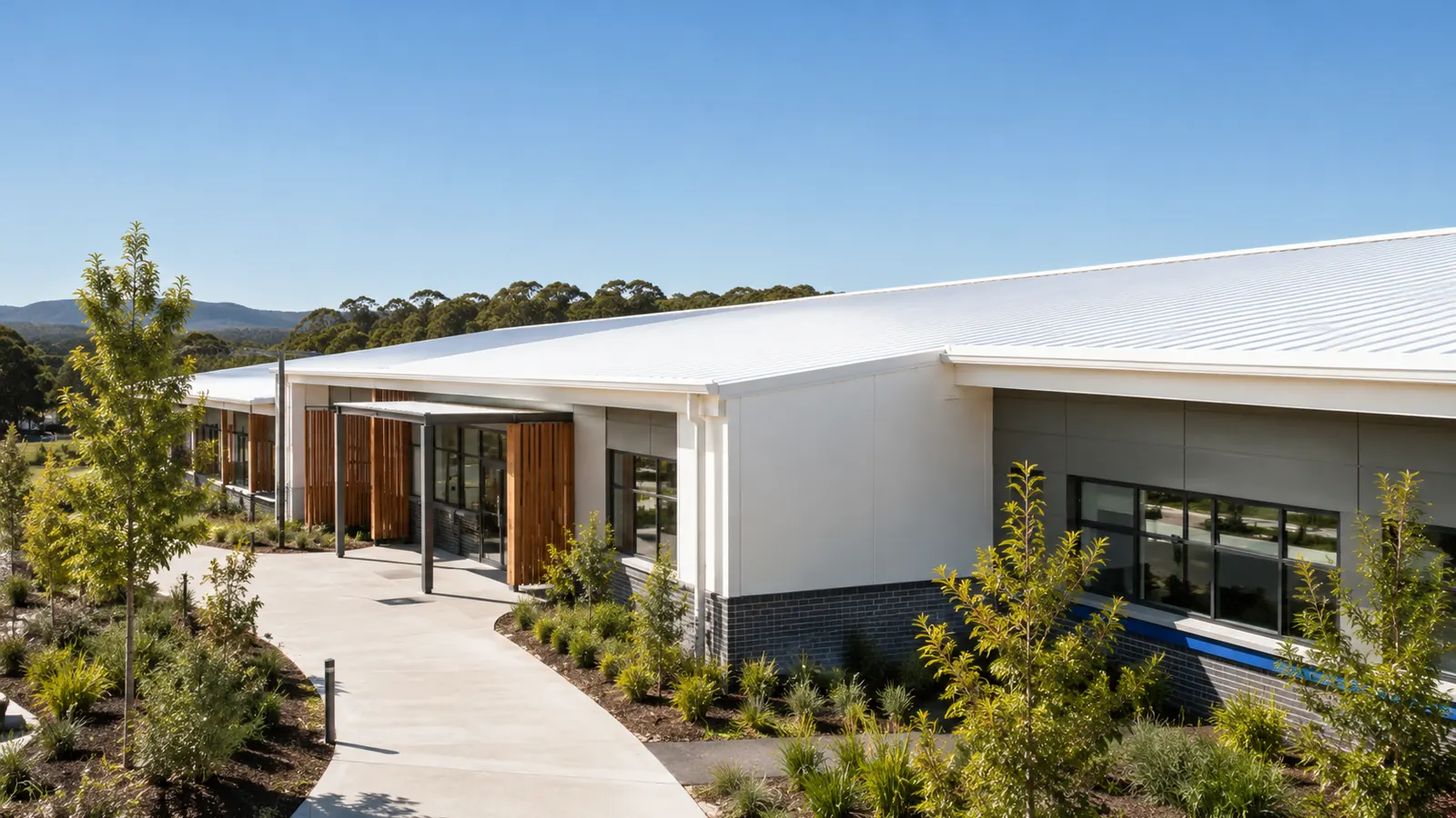 School or community facility building with a covered walkway, illustrating a NusCoolWall™ application scenario